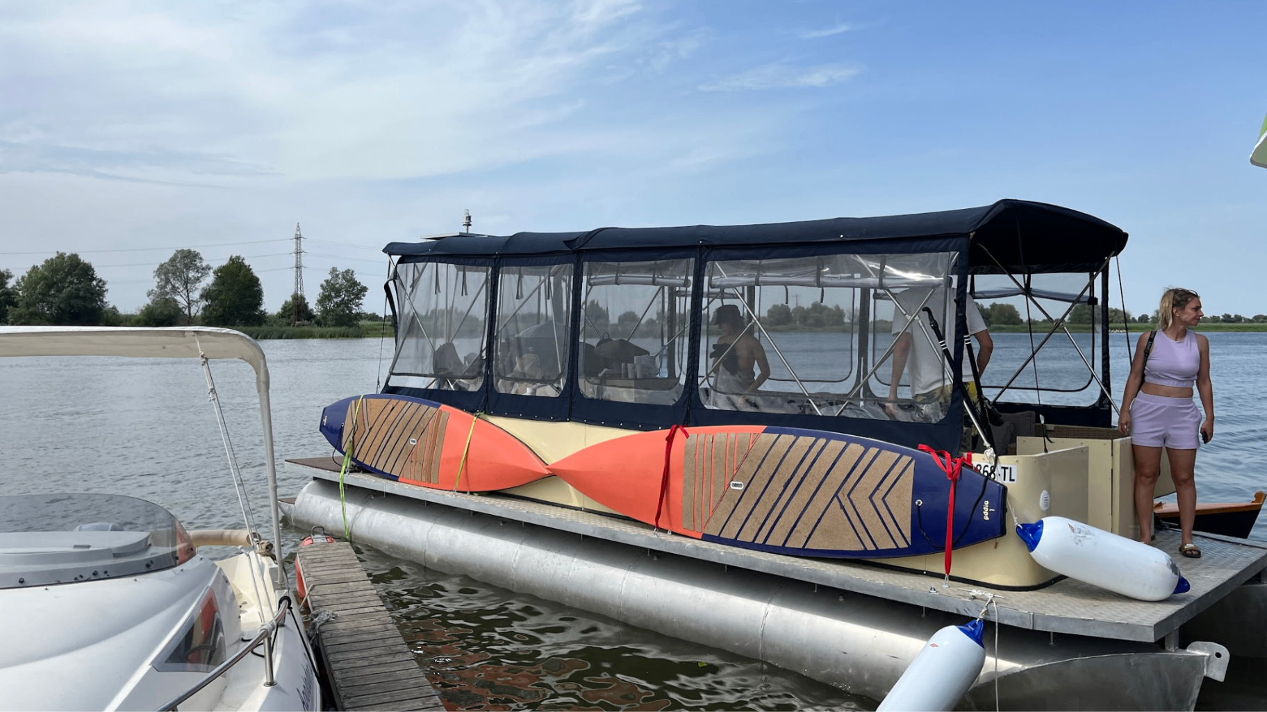 SUP boards prepared on the catamaran at the pontoon
